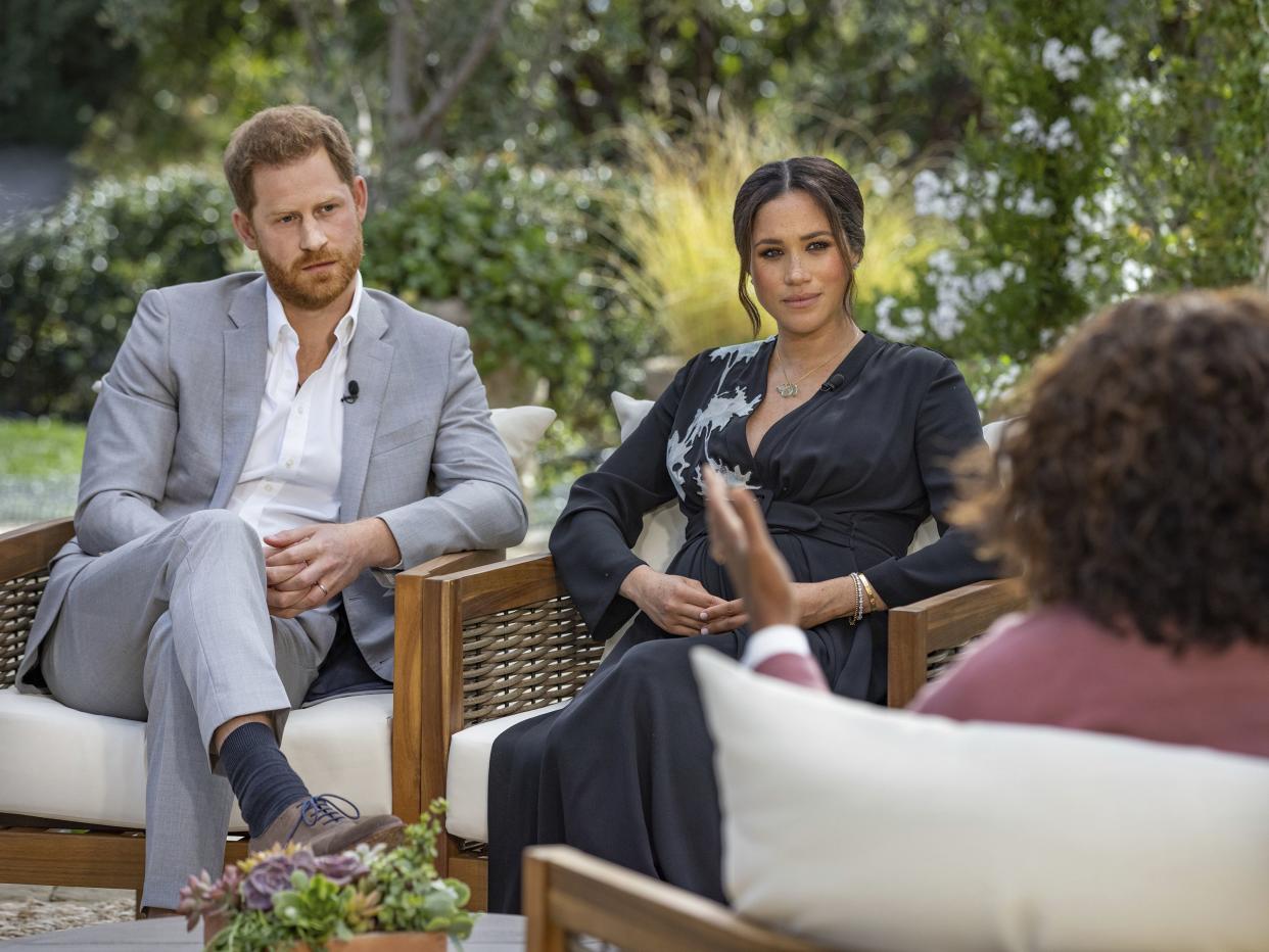 This image provided by Harpo Productions shows Prince Harry, from left, and Meghan, Duchess of Sussex, during an interview with Oprah Winfrey. 