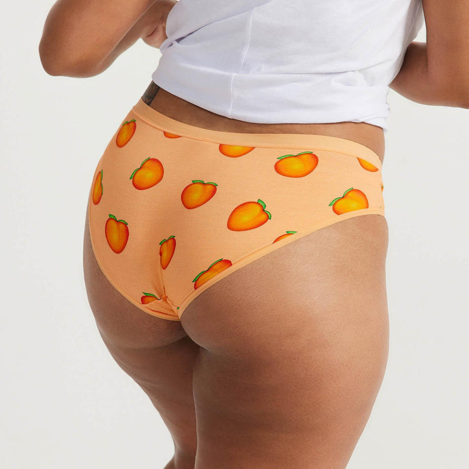 woman's bum seen in three-quarter profile wearing Oodie Peach Emoji Briefs, $19