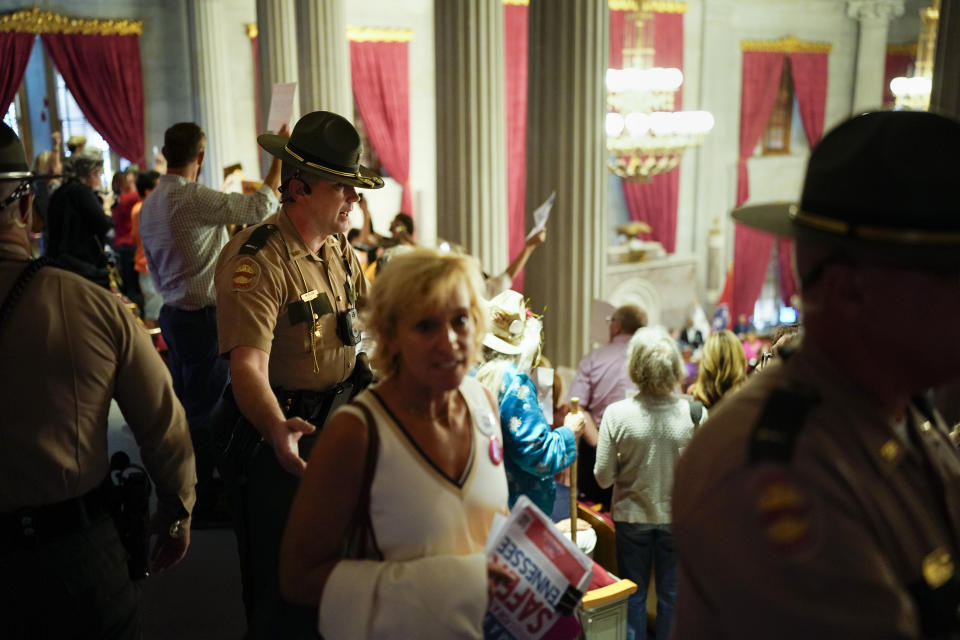 A Tennessee State Trooper, left, removes people from the gallery after an order from the House Speaker during a special session of the state legislature on public safety Monday, Aug. 28, 2023, in Nashville, Tenn. (AP Photo/George Walker IV)