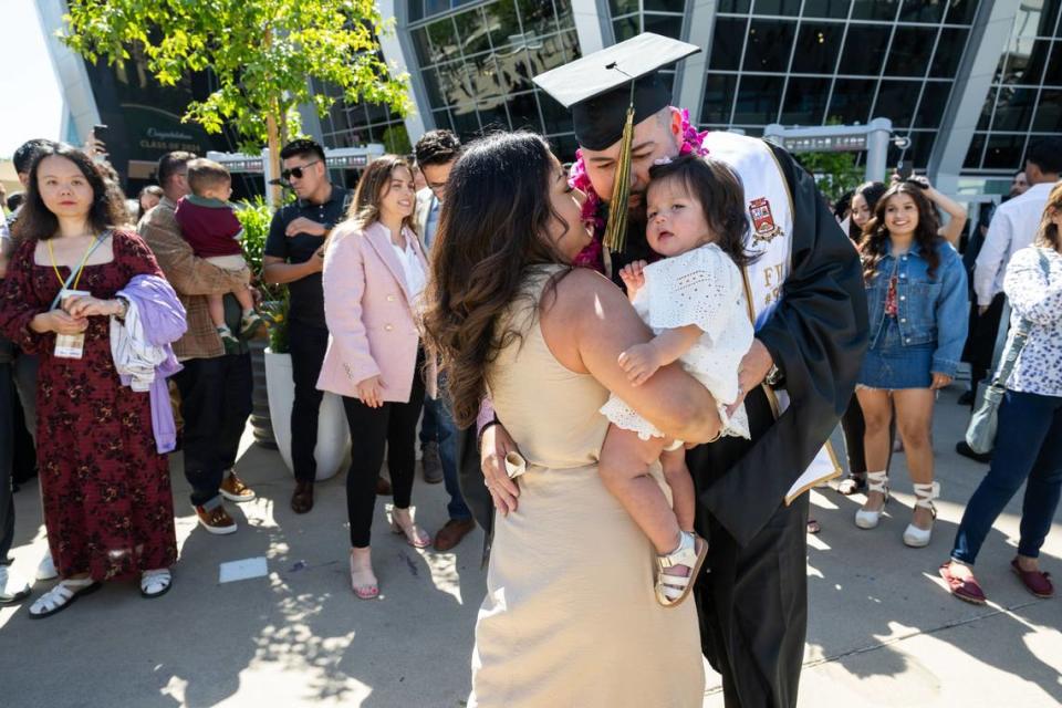 Sacramento State business graduate Jose Lopez dances with his wife Juliana and their daughter after the second commencement ceremony at Golden 1 Center on Friday, May 17, 2024.