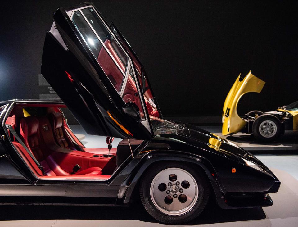 A Lamborghini Countach 5000 QV (left) and a golden Lamborghini Miura S Serie II are on display at a museum in Germany in this 2018 photo. Both cars represent the apex of older Lamborghini designs.