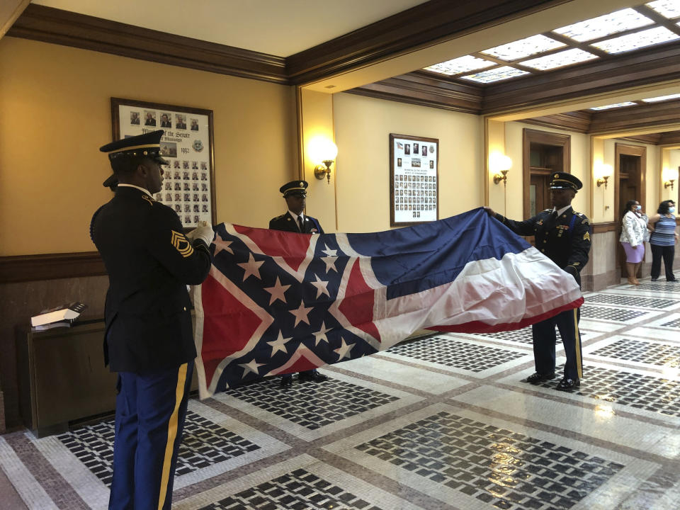 Honor guard members from the Mississippi National Guard practice folding the former Mississippi flag before a ceremony to retire the banner on Wednesday, July 1, 2020, inside the state Capitol in Jackson. The ceremony happened a day after Republican Gov. Tate Reeves signed a law that removed the flag's official status as a state symbol. The 126-year-old banner was the last state flag in the U.S. with the Confederate battle emblem. (AP Photo/Emily Wagster Pettus)