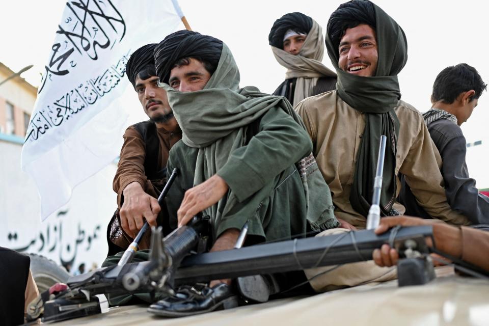 August 31, 2022: Taliban fighters travel in a vehicle as they celebrate the first anniversary of the withdrawal of US-led troops from Afghanistan near the airport in Kabul. - The Taliban declared August 31 a national holiday. They lit up the capital with colored lights to celebrate the first anniversary of the withdrawal of US-led troops from Afghanistan after a brutal 20-year war.