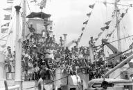 <p>Officers aboard the Tank Landing Ship HMS LST 538 cheer and celebrate as signal flags are hoisted upon word from Delhi announcing the end of hostilities in Europe, off Ramree Island, Burma.</p>