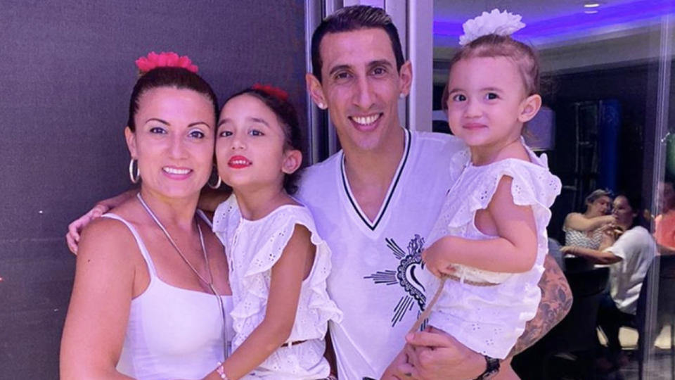 PSG's Angel Di Maria (pictured with family) smiles for a photo.