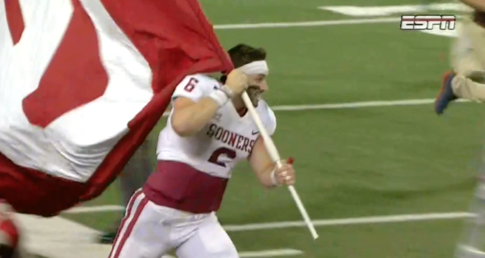 Baker Mayfield planted an Oklahoma flag on Ohio State’s logo after the Sooners’ win. (Screen capture)
