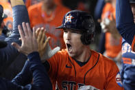 Houston Astros' Alex Bregman (2) celebrates in the dugout after hitting a home run against the Texas Rangers during the first inning in Game 5 of the baseball American League Championship Series Friday, Oct. 20, 2023, in Arlington, Texas. (AP Photo/Godofredo A. Vásquez)