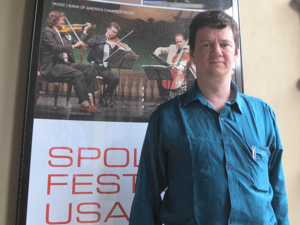 Tom Morris, the artistic director for Bristol Old Vic in the United Kingdom, stands outside the Dock Street Theatre in Charleston, S.C., on May 23, 2013. Morris is directing a new version of Shakespeare's "A Midsummer Night's Dream" for the 2013 Spoleto Festival USA. The internationally known arts festival, founded in Charleston in 1977 by the late composer Gian Carlo Menotti, continues through June 9 and features 160 performances. (AP Photo/Bruce Smith)