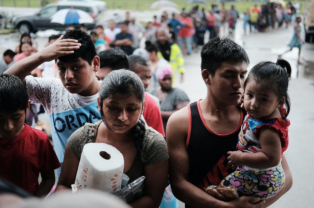 <span class="caption">Migrant workers in a Florida community hit hard by Hurricane Irma line up for donated supplies.</span> <span class="attribution"><a class="link " href="https://www.gettyimages.com/detail/news-photo/residents-of-the-rural-migrant-worker-town-of-immokalee-news-photo/846617080" rel="nofollow noopener" target="_blank" data-ylk="slk:Spencer Platt/Getty Images;elm:context_link;itc:0;sec:content-canvas">Spencer Platt/Getty Images</a></span>