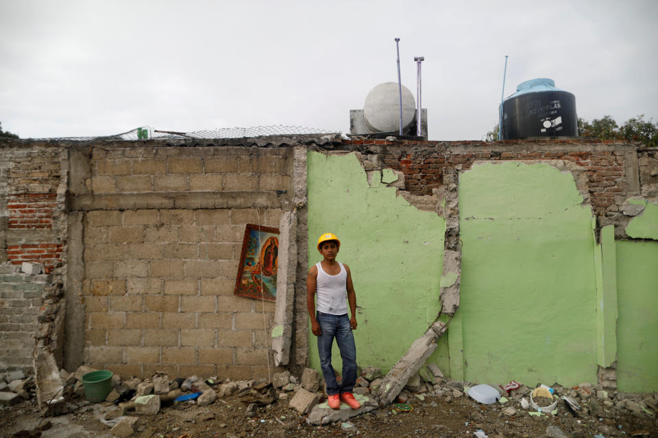 <p>Jaime Delgado, 21, an agricultural worker, poses for a portrait on rubble in an area where he helped rescue people, after an earthquake in Jojutla de Juarez, Mexico, September 30, 2017. His house was not damaged. “A lady died here, crushed by the rubble. All this is over, now I searches pieces of iron to sell. My economic situation is bad”, Delgado said. (Photo: Edgard Garrido/Reuters) </p>