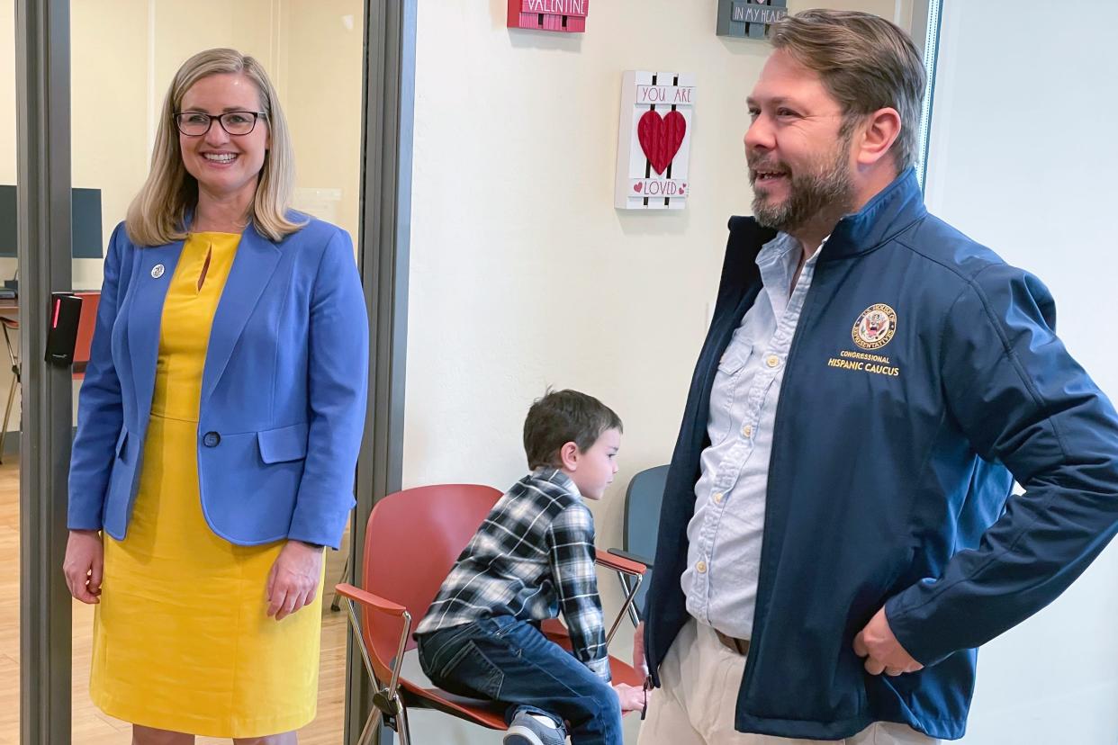 U.S. Rep. Ruben Gallego, D-Ariz., and his ex-wife, Phoenix Mayor Kate Gallego, tour an affordable housing development in Phoenix along with their 6-year-old son, Michael Gallego, on March 19, 2023.