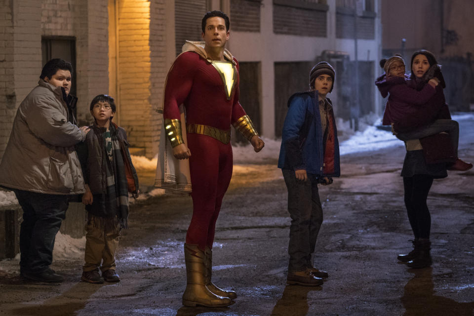 This image released by Warner Bros. shows Zachary Levi, center, and Jack Dylan Grazer, center right, in a scene from "Shazam!" (Steve Wilkie/Warner Bros. Entertainment via AP)