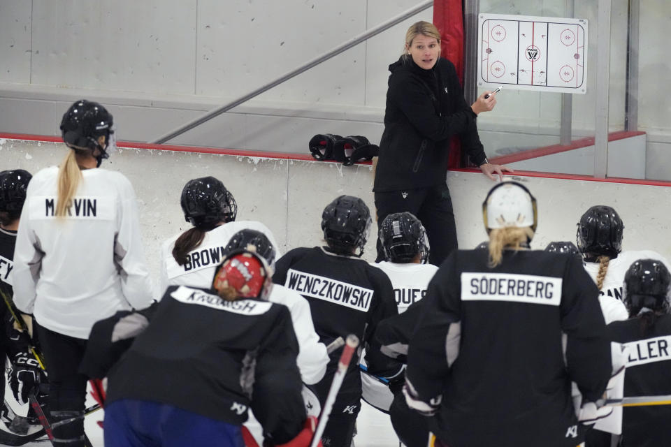 Courtney Kessel, head coach of the Boston-based team of the Professional Women's Hockey League, instructs her players during a team hockey practice ahead of their season, Monday, Nov. 20, 2023, in Wellesley, Mass. Puck drop will follow the New Year's ball drop for the the newly established Professional Women's Hockey League in kicking off its inaugural schedule with Toronto hosting New York on Jan. 1. (AP Photo/Charles Krupa)