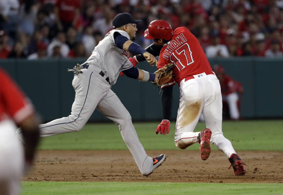 Los Angeles Angels' Shohei Ohtani (17) is tagged out by Houston Astros third baseman Yuli Gurriel on a rundown between second and third base following a ground ball by Justin Upton during the second inning of a baseball game Tuesday, July 16, 2019, in Anaheim, Calif. (AP Photo/Marcio Jose Sanchez)