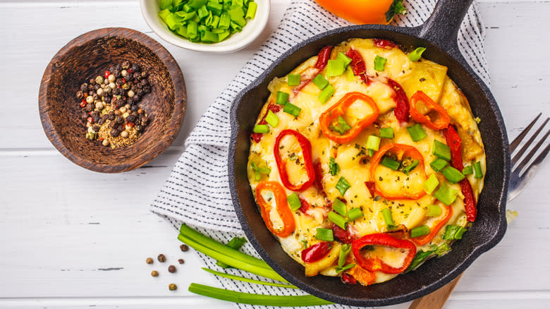 Frittata in skillet with toppings