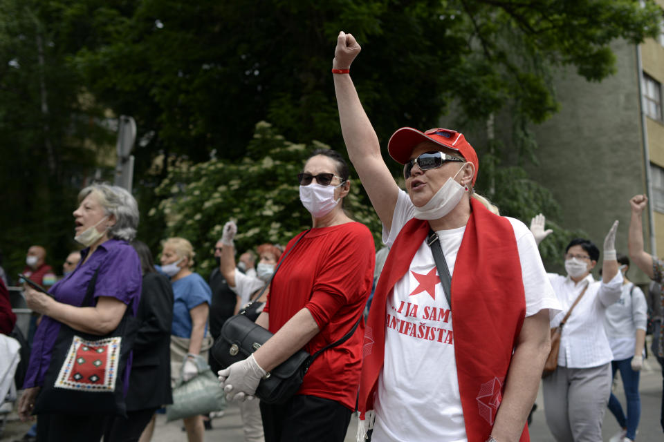 A man wearing "I too am an anti-Fascist' shout slogans during an anti-Nazi protest outside the Sacred Heart Cathedral during a mass commemorating members of the pro-Nazi Croatian WWII Ustasha regime, responsible for sending tens of thousands of Serbs, Gypsies and Jews to their death in concentration camps, who were killed at the end of WWII by Yugoslav communist troops, in Sarajevo, Bosnia, Saturday, May 16, 2020. Bosnian Catholic clerics along with Croatian state representatives and members of the Bosnian Croats community attended a religious service commemorating the massacre of Croatian pro-Nazis by victorious communists at the end of World War II. (AP Photo/Kemal Softic)