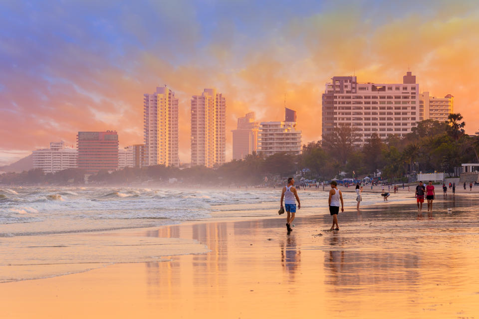 A photo of tourists at Hua Hin beach in the evening. 