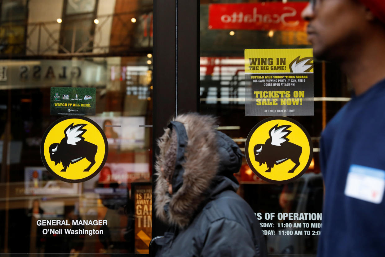 A pedestrian walks past a Buffalo Wild Wings restaurant in New York, U.S., February 6, 2017.  REUTERS/Lucas Jackson