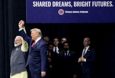 U.S. President Donald Trump and India's Prime Minister Narendra Modi gesture during the "Howdy Modi" event in Houston