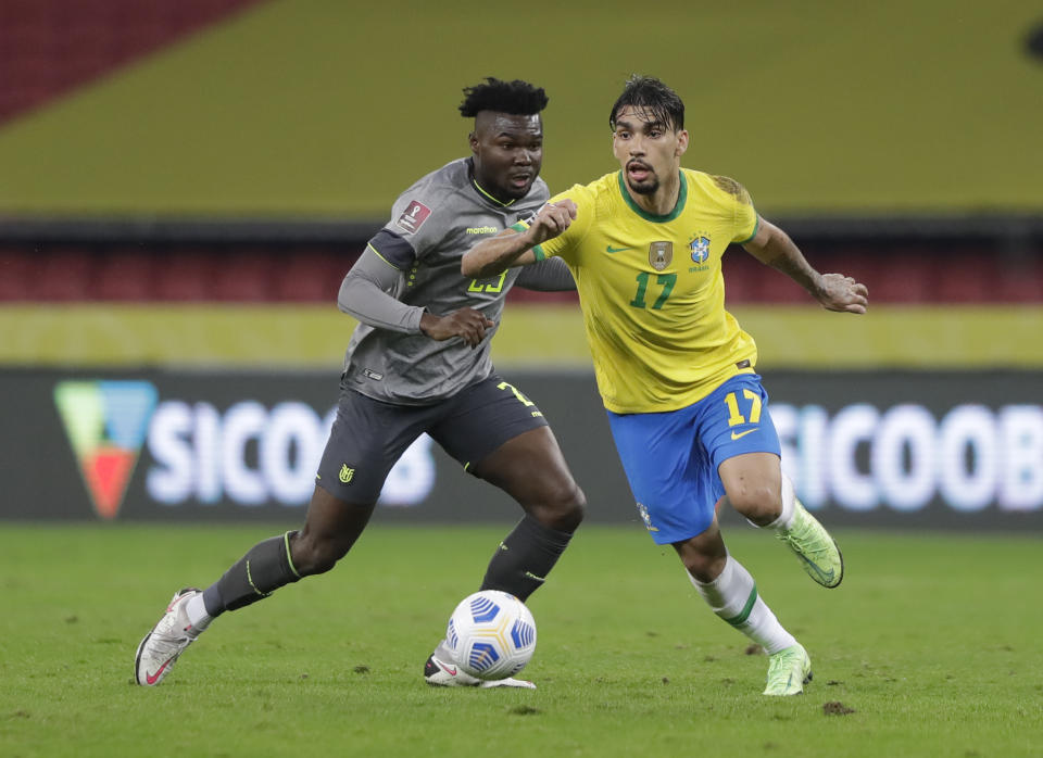 Brazil's Lucas Paqueta, left, and Ecuador's Jordy Caicedo fight for the ball during a qualifying soccer match for the FIFA World Cup Qatar 2022 at Beira-Rio stadium in Porto Alegre, Brazil, Friday, June 4, 2021. (AP Photo/Andre Penner)