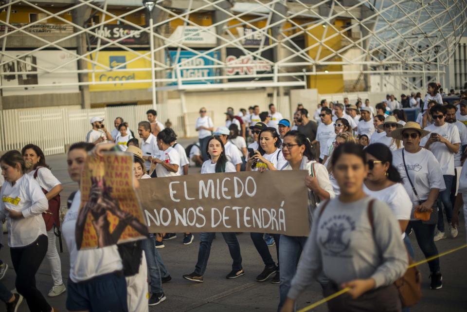 People attend a march coined "Culiacan Valiente," or Brave Culiacan, to protest violence and demand safety, some carrying the Spanish sign "Fear will not stop us," in Culiacan, Mexico, Sunday, Oct. 27, 2019. Residents are still coming to grips with the worst cartel violence in recent memory, in which 13 people were killed including at least three innocents caught in the crossfire, on Oct. 17, a date now known as “Black Thursday.” (AP Photo/Augusto Zurita)