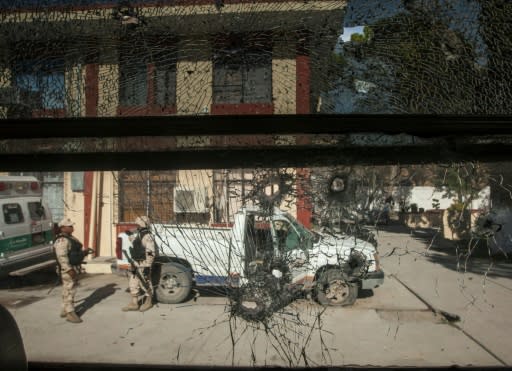 Soldiers stand guard in front of the city hall in Villa Union, Mexico on December 2