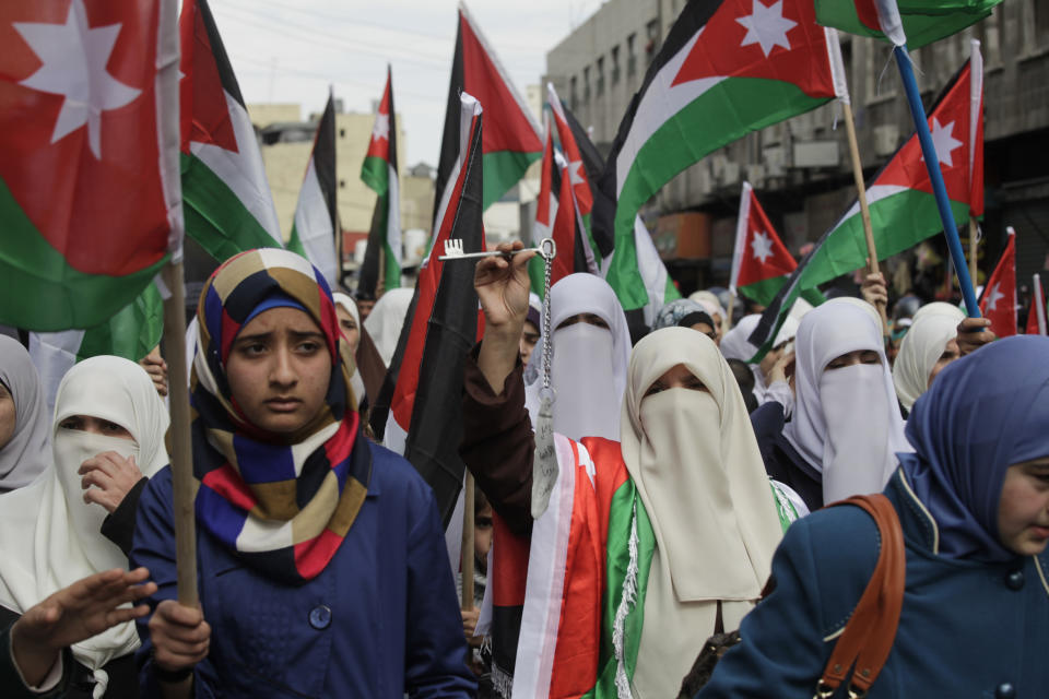 Female protesters affiliated with Jordan's Muslim Brotherhood chant anti-Israel and anti-America slogans during a demonstration in downtown Amman, Jordan, Friday, Feb. 14, 2014. Hours before Jordan's King Abdullah II met with U.S. President Barack Obama in California, his Islamist opposition at home has staged its largest protest in several months to reject a peaceful Mideast settlement. (AP Photo/Mohammad Hannon)