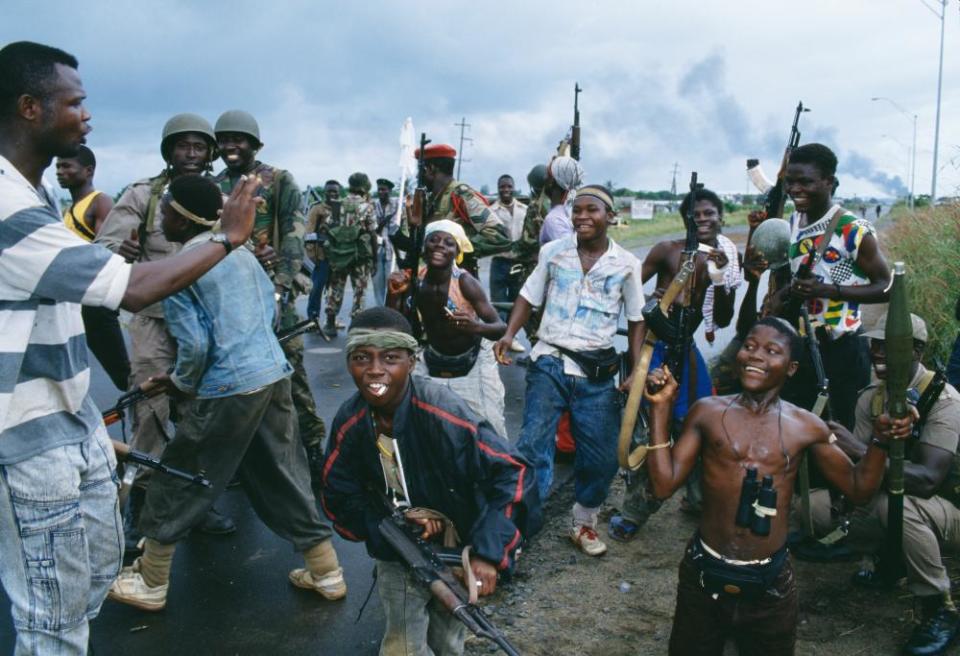 Young rebels posing and ECOMOG soldiers in Monrovia during the Liberian civil war.