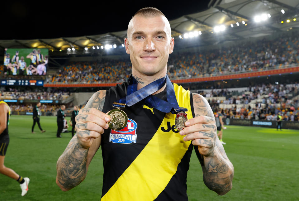 Dustin Martin, pictured here with his Norm Smith and Premiership Medal after the AFL grand final in 2020.