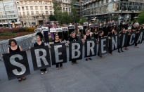 <p>Members of anti-war organization “Women in Black”, hold banners that read: “SREBRENICA” as part of a meeting to mark the 22th anniversary of the Srebrenica tragedy when in 1995 Bosnian Serb forces stormed the enclave and systematically killed thousands of Bosnian Muslims, in downtown Belgrade, Serbia, Monday, July 10, 2017. (Photo: Darko Vojinovic/AP) </p>