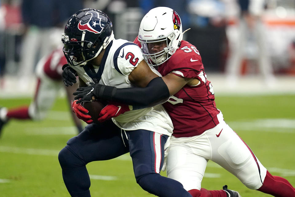 Houston Texans running back Mark Ingram (2) is tackled by Arizona Cardinals middle linebacker Jordan Hicks (58) during the first half of an NFL football game, Sunday, Oct. 24, 2021, in Glendale, Ariz. (AP Photo/Ross D. Franklin)