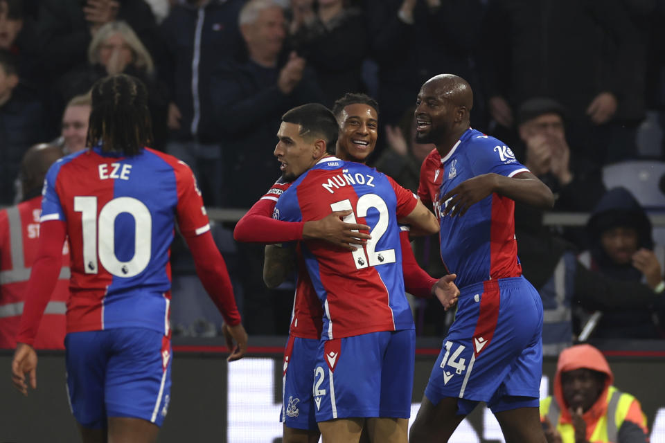 Crystal Palace's Michael Olise, centre, celebrates with teammates after scoring his side's opening goal during the English Premier League soccer match between Crystal Palace and Manchester United at Selhurst Park stadium in London, England, Monday, May 6, 2024. (AP Photo/Ian Walton)