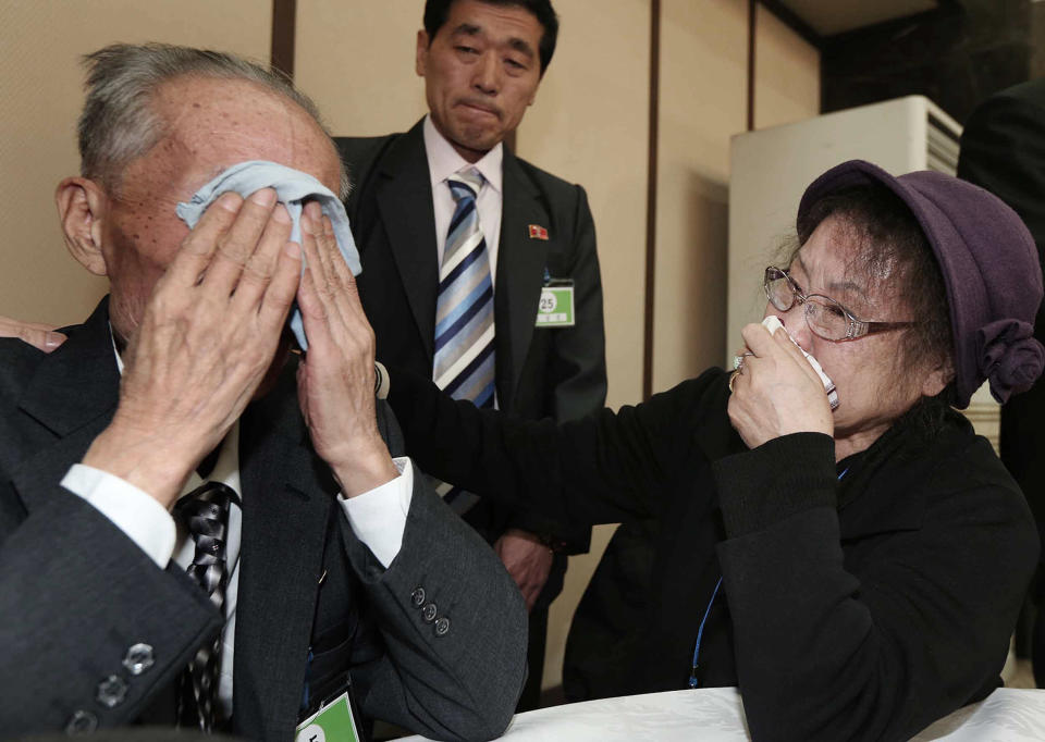 North Korean Jeon Young Ui, left, weeps with his South Korean sister Kim Kyung-sook during the Separated Family Reunion Meeting at Diamond Mountain resort in North Korea, Sunday, Feb. 23, 2014. Elderly North and South Koreans separated for six decades are tearfully reuniting, grateful to embrace children, brothers, sisters and spouses they had thought they might never see again. (AP Photo/Yonhap, Lee Ji-eun) KOREA OUT