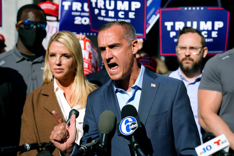 Donald Trump's former campaign advisor Corey Lewandowski, center, speaks outside the Pennsylvania Convention Center where votes are being counted, Thursday, Nov. 5, 2020, in Philadelphia. At left is former Florida Attorney General Pam Bondi.