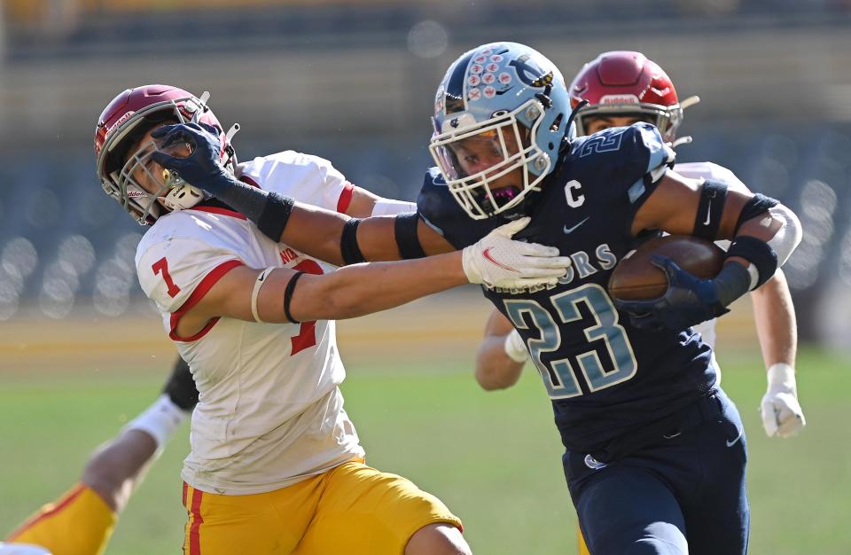 Central Valley's Landon Alexander (23) stiff-arms North Catholic's Gavin Kamody during the WPIAL Class 3A championship game in November.