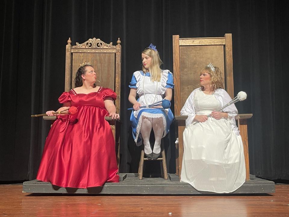 The Red Queen, left, played by Danielle Clarke, and the White Queen, right, played by Molly Ann, grill Alice, played by Elizabeth Jordan.