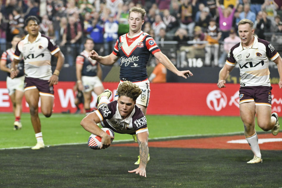 Broncos Reece Walsh scores a try during the NRL match between the Sydney Roosters and the Brisbane Broncos at Allegiant Stadium in Las Vegas, Saturday, March 2, 2024. (AP Photo/David Becker)