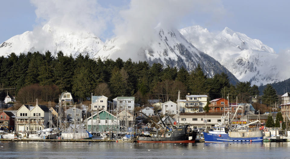 FILE - Homes in downtown overlook the harbor, in Sitka, Alaska, on March 26, 2008. Sitka is the home port for a charter fishing boat that sank in late May 2023 in nearby waters killing three and leaving two lost at sea. The tragedy has put a spotlight on the safety of southeast Alaska's vibrant charter fishing industry and on the port town of Sitka, where charter operators charge thousands of dollars per person for guided fishing trips. (AP Photo/Chris Miller, File)