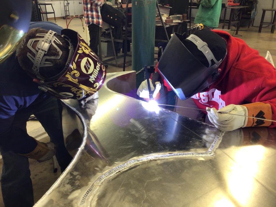 Alliance High School welding students work on the Aviators sign.