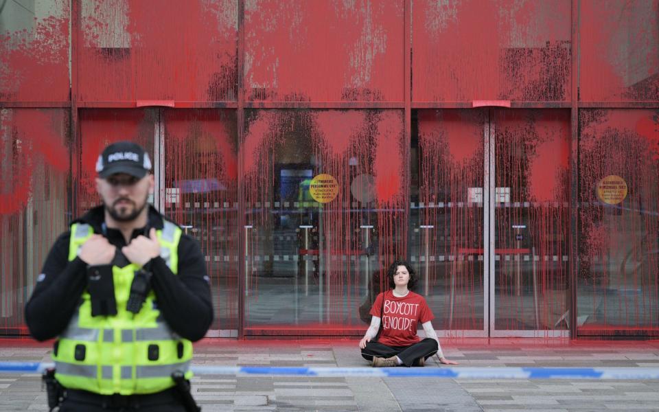 Police and activists at Queen Elizabeth House in Edinburgh