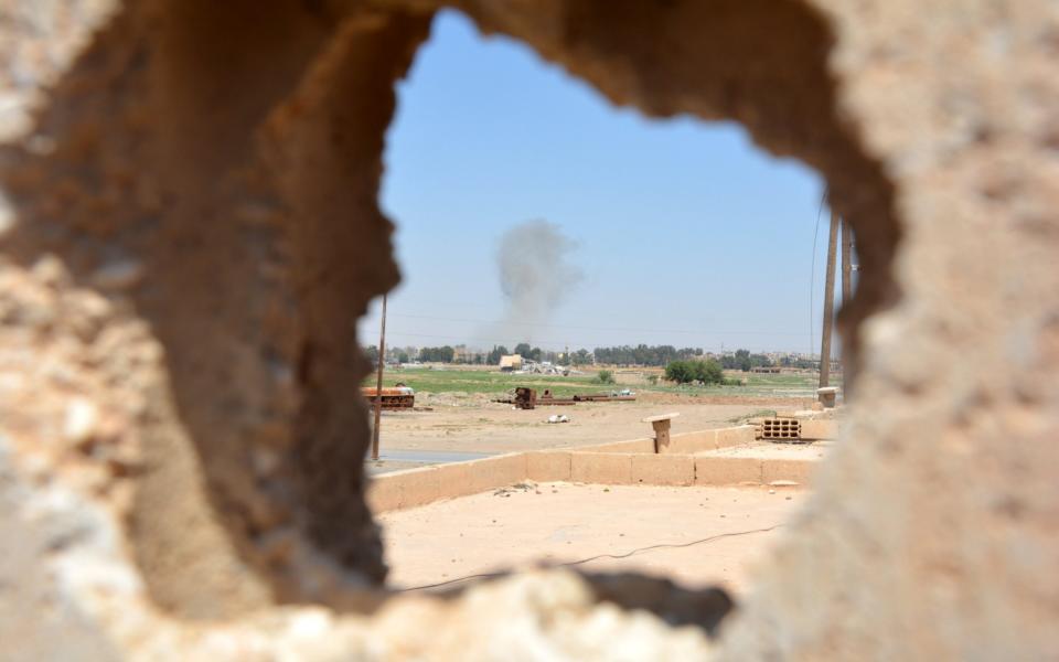 A smoke cloud billows during fighting at Raqqa city, Syria, 11 June 2017 - Credit: EPA