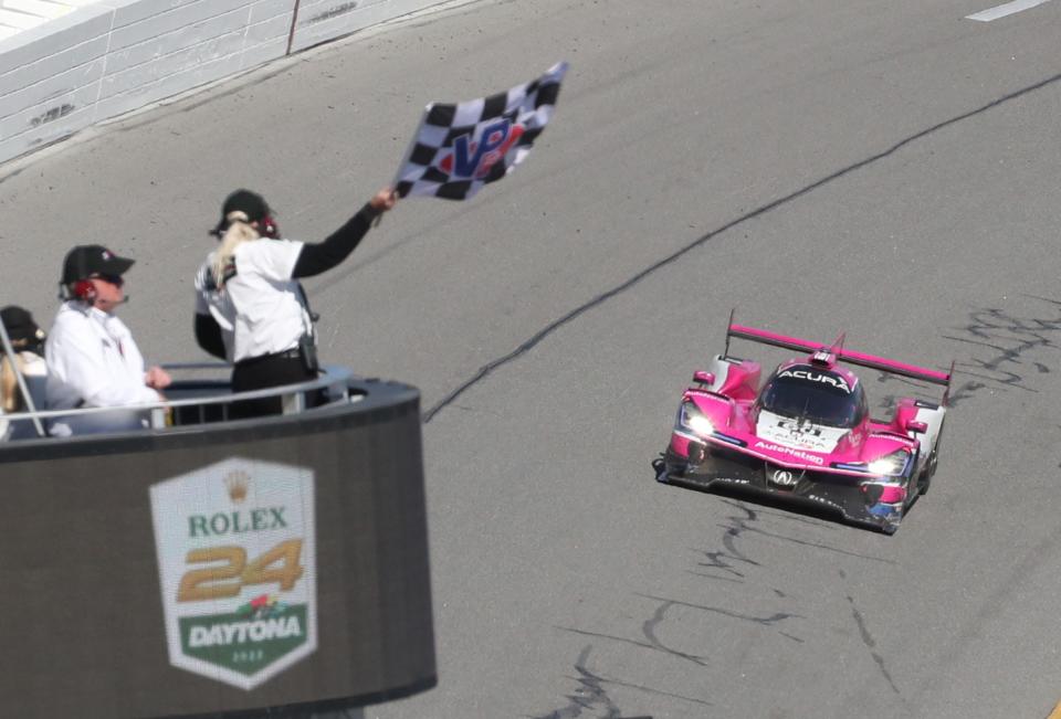 Helio Castroneves in the no. 60 Acura DPi takes the checkered flag to win the 60th Rolex 24, Sunday January 30, 2022 at Daytona International Speedway.