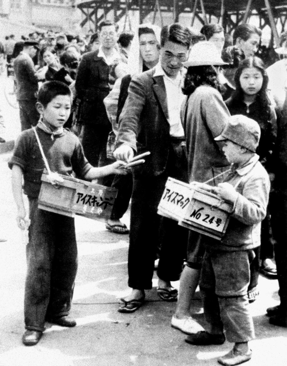 War orphans sell ice candy near Ueno station in Tokyo May 7, 1948. In Japan, war orphans were punished for surviving. They were bullied. They were called trash, sometimes rounded up by police and put in cages. Some were sent to institutions or sold for labor. They were targets of abuse and discrimination. A 1948 government survey found there were more than 123,500 war orphans nationwide. (Kyodo News via AP)