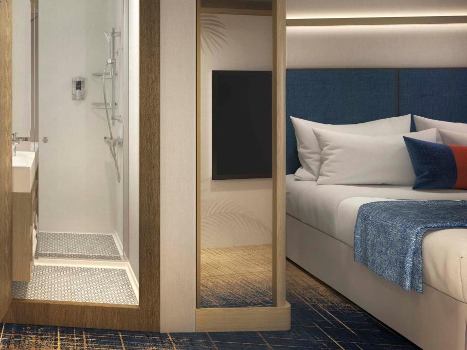 A rendering of the two bathrooms and a bed in Royal Caribbean's upcoming Icon of the Seas cruise ship