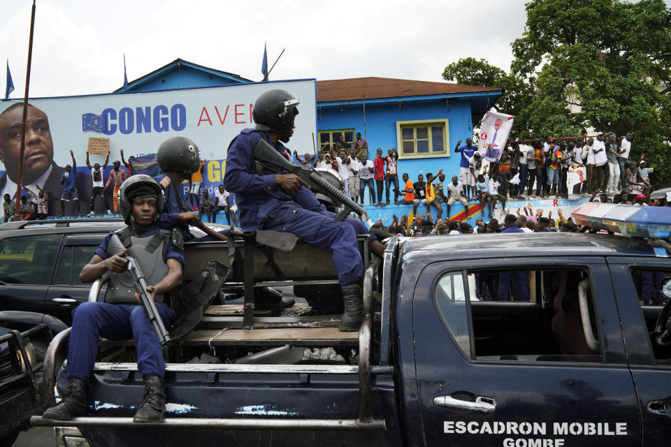 Congolese police take position outside the headquarters of Jean Pierre Bemba's MDC party where Congo opposition candidate Martin Fayulu addressed supporters in Kinshasha, Congo, Friday, Jan. 11, 2019. Hundreds gathered to denounce what they called "the people's stolen victory" in the presidential election. (AP Photo/Jerome Delay)