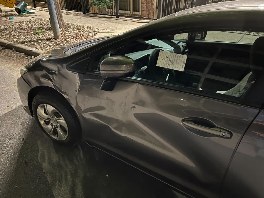 Damage to cars, street signs, etc. along East 9th Street near Embassy Drive after an 18-wheeler crashed into 10 parked vehicles overnight April 22, 2024 (KXAN Photo/Todd Bailey)