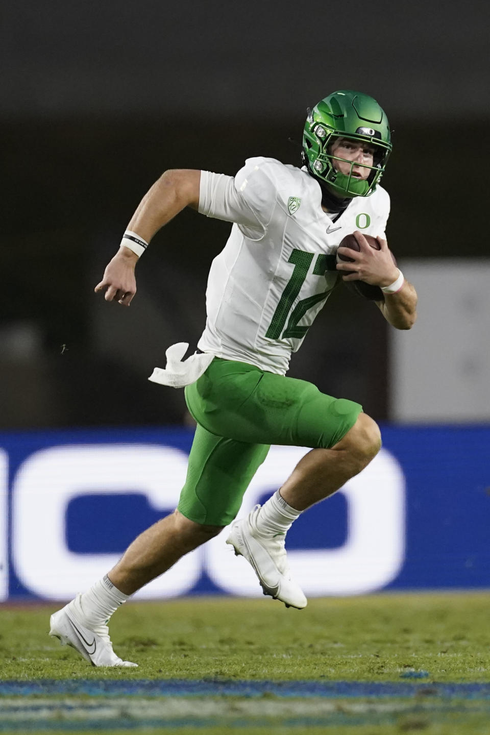 Oregon quarterback Tyler Shough (12) runs the ball during the second quarter of an NCAA college football game for the Pac-12 Conference championship against Southern California Friday, Dec 18, 2020, in Los Angeles. (AP Photo/Ashley Landis)