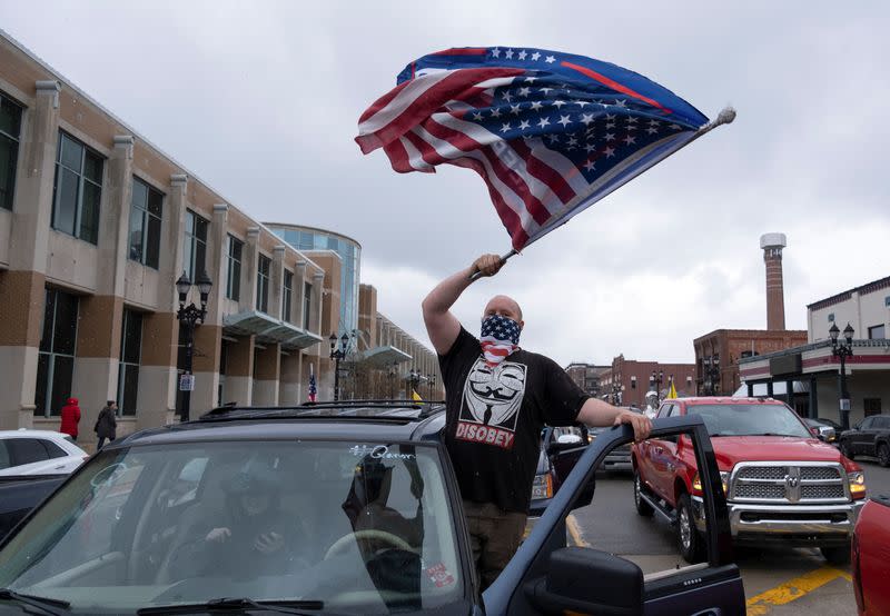 Protesters against the state's extended stay-at-home order demonstrate in Lansing