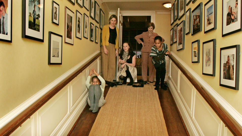 Laura Bush, Jenna Hager and Barbara Bush welcome Michelle Obama, her mother, Marian Robinson, and her children Malia and Sasha for a tour of the White House. The girls slide down the ramp, Private Residence. (Joyce N. Boghosian / White House Photo Office)