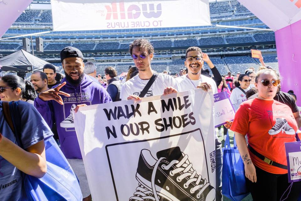 Team Walk A Mile N Our Shoes -- Eugene Campbell III, Kevin Damm and Christopher Lugo -- go through the MetLife Stadium tunnel at the start of the 2023 Lupus Walk.